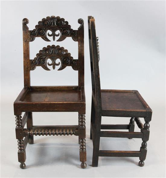 A set of twelve 17th century style Derbyshire oak dining chairs, H.3ft 5in.
